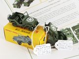 a toy army vehicle and a toy army truck on a book