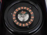 a roulet wheel in a box with a clock on it