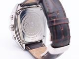 a close up of a watch on a white surface