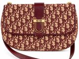 a brown and tan purse with a brown strap