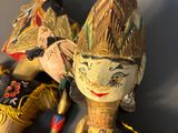 three wooden dolls that are sitting on a table