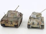 two toy tanks sitting next to each other on a white surface