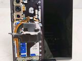 someone is removing the back panel of a samsung galaxy note 8