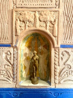 a statue of a woman in a niche on a wall