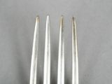 two forks are sitting next to each other on a table