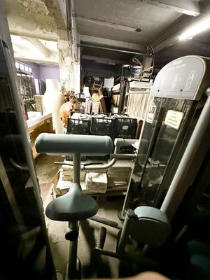 a gym room with a tread machine and other equipment