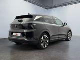 the rear end of a grey suv parked in a garage
