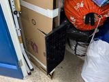 a pile of boxes and bags on the floor next to a blue door