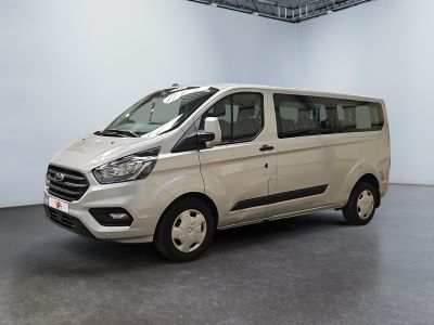 the white van is parked in the large room of the building