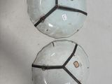 two white and black balls on a white surface