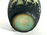 a black and white vase sitting on a white surface