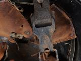 a close up of an old helmet with leathers on it