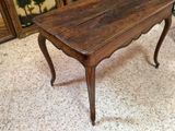 a small table with a wooden top in a room