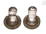pair of silver earrings with a snake on each side of them