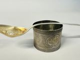 silver plated spoon with handle and handle on white surface