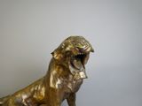 a bronze statue of a dog with its mouth open