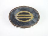 a picture of a silver and gold broochle on a white surface