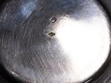 a close up of a metal pan with a hole in it