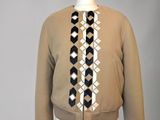 jacket on a mannequin stand with a black and white tie on it