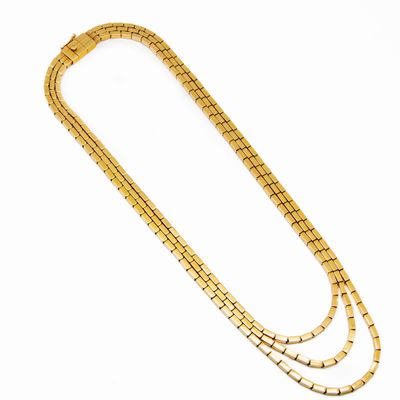 a gold necklace with three rows of gold chains