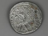 an old silver coin with an image of a man on it