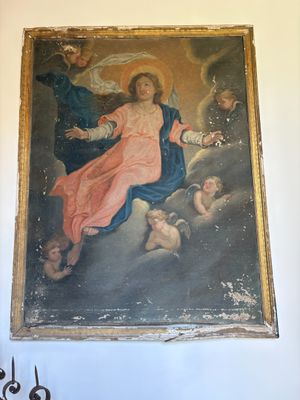 a painting on the wall of a room with a painting of jesus