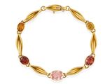 a gold bracelet with multi colored stones on a white background