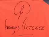 an orange vest with writing on it that says frances ' s letterer