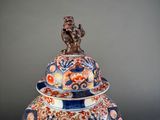 a large vase with a monkey on top of it