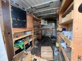 a small room with shelves and a television in it