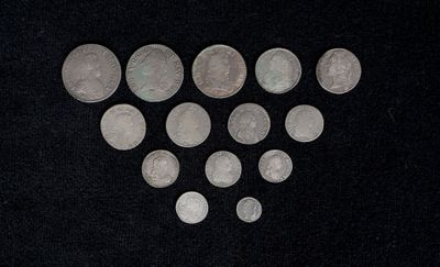 some silver coins are arranged in the shape of a heart