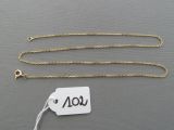 a close up of a gold chain with a price tag on it
