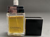 a close up of a bottle of perfume on a table