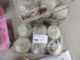 many cans of food that are sitting on a table
