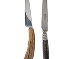 two knives that are next to each other on a white surface