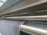 a close up of a machine that is working on a piece of fabric