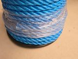 a close up of a spool of blue rope on a table