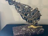 a sculpture of a bird made out of chains on a table