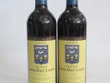 two bottles of wine sitting next to each other on a table