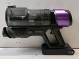 a black and purple cordless vacuum on a table