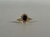 a close up of a gold ring with a blue stone