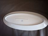 a white platter with a blue cross on it