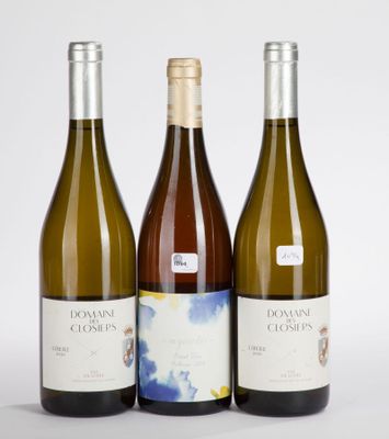 three bottles of white wine sitting next to each other on a table