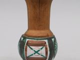 a small vase with a wooden handle on a white background