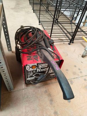 a red box with a black handle sitting on the floor