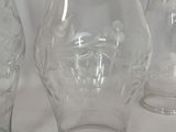 three glass vases sitting on a table with a white background