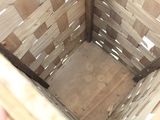 a wooden basket that has a handle on it