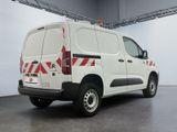 a white van with red and white stripes parked in a garage