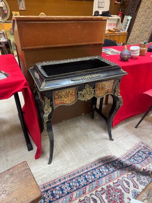 a small table with a red table cloth on it