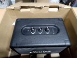 a black amp sitting in a box on the floor
